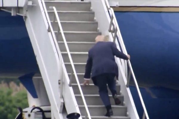 Donald Trump falls on the stairs while boarding Air Force One.