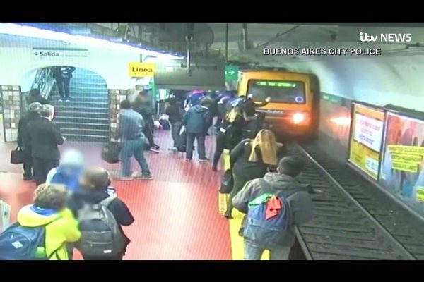 Woman saved after she is pushed onto train tracks by fainting passenger in freak accident | ITV News